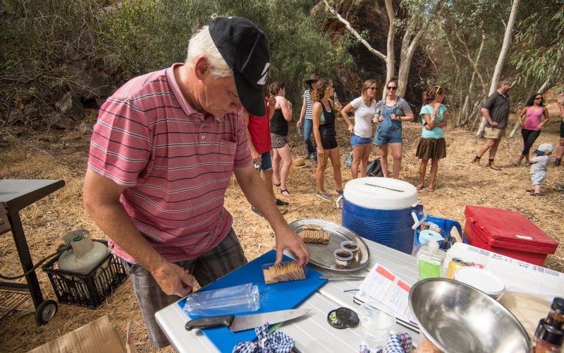 Person helping to prepare food on a camping trip.