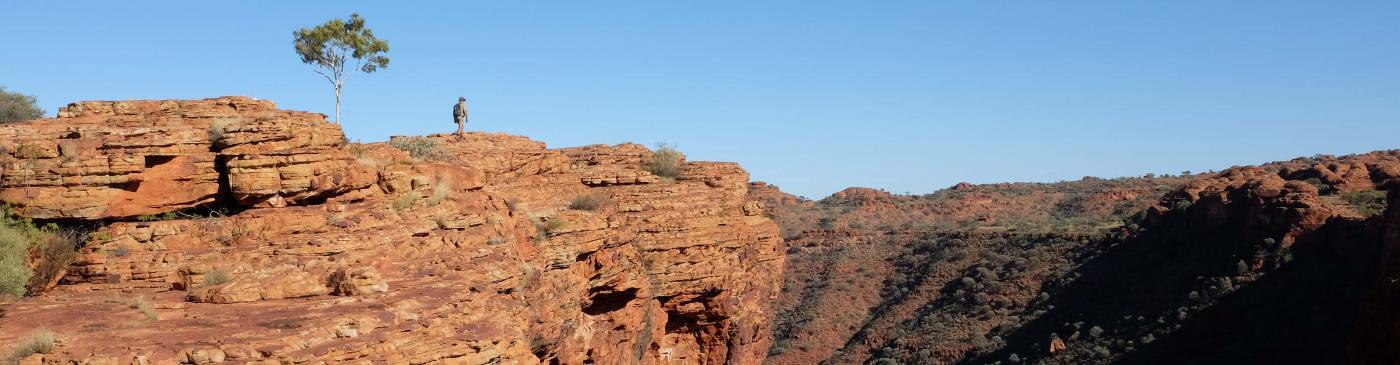 Man walking over Kings Canyon in the Australian Northern Territory