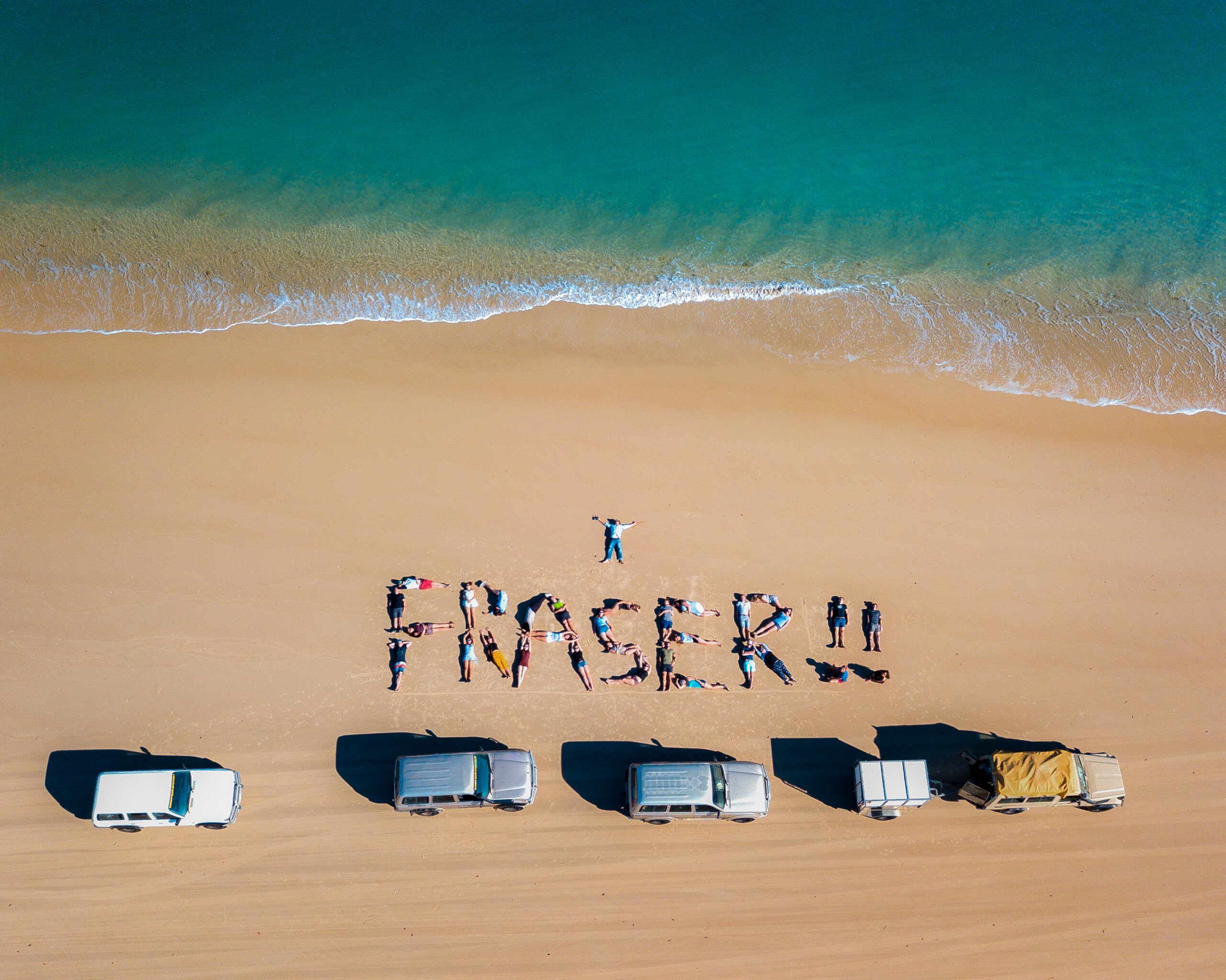 People writing Fraser on the beach
